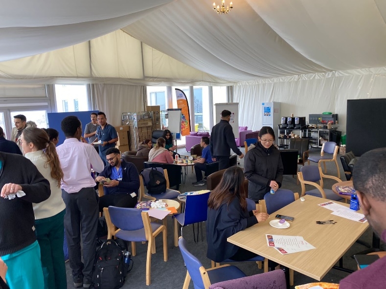 people in a room with tables and chairs